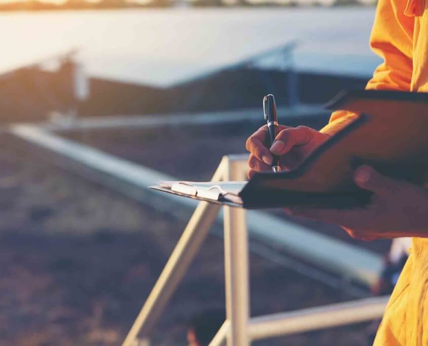 O3_Interior_solar worker writing on clipboard