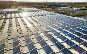 Commercial solar panels with sun shining on them