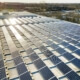 Commercial solar panels with sun shining on them