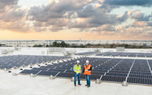 O3 team standing on top of a building with solar panels
