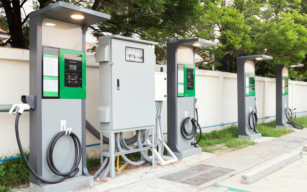 Grey and green EV charging stations in lot Grey and green EV charging stations in lot